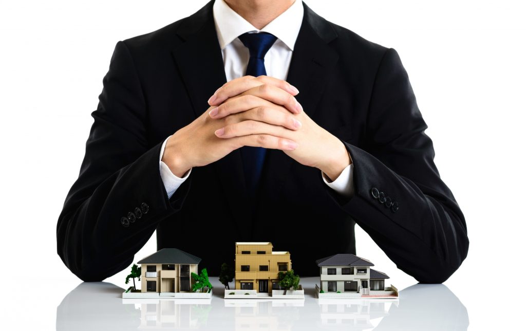 スーツの男性と家の模型